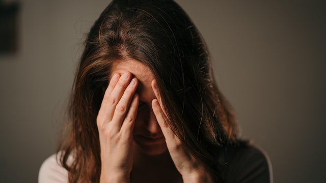 Frustrated, asian woman and headache with stress in city for strain, pressure or discomfort at outdoor park. Female person or migraine with pain, ache or vertigo for dizziness in an urban town 